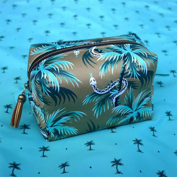 Waterproof zip make up bag with tropical snakes and palm tree pattern by Andrea Muller