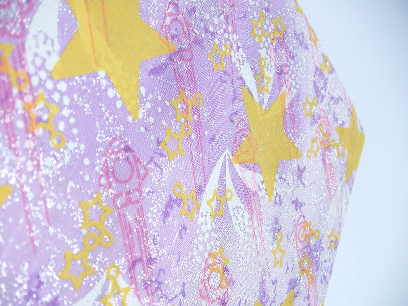 Purple cotton fabric with stars, comets and rockets