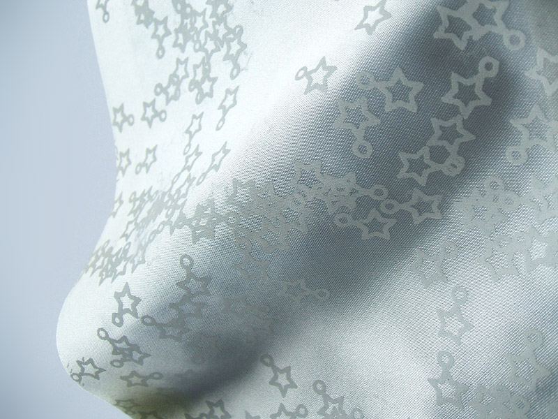 White satin fabric with opaque star screenprint