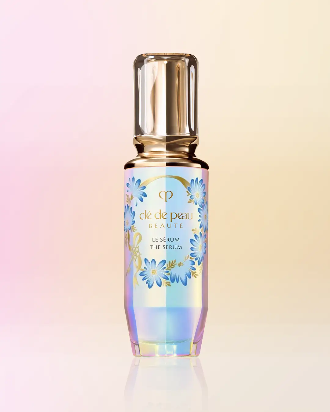 Clé de Peau Beauté serum bottle design with blue daisy wreath by Andrea Muller