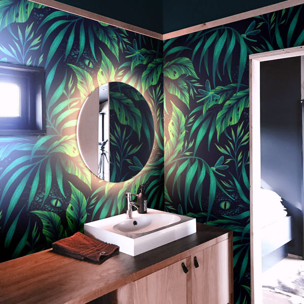 Wallpaper with green tropical leaves and hidden dinosaurs by Andrea Muller