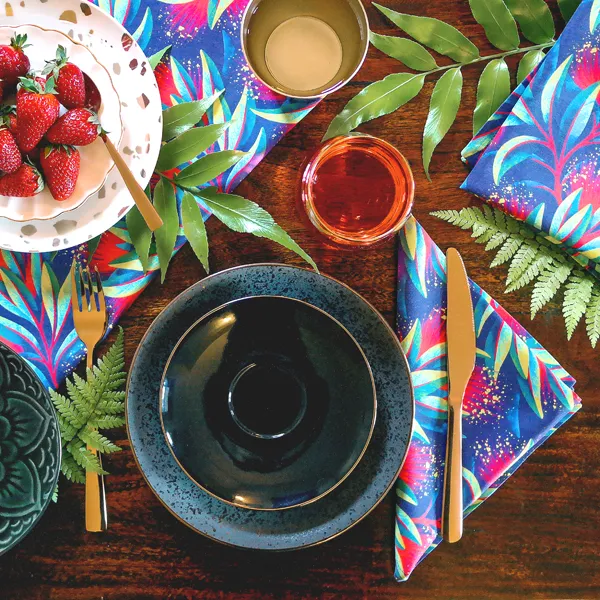 Red and green Pohutukawa floral table napkins by Andrea Muller